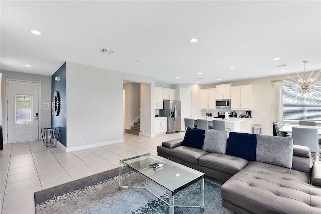 living area featuring light tile patterned flooring, recessed lighting, visible vents, stairs, and an inviting chandelier