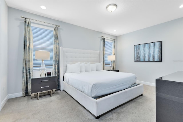 bedroom featuring recessed lighting, light colored carpet, and baseboards