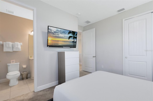 tiled bedroom with baseboards, visible vents, and carpet flooring