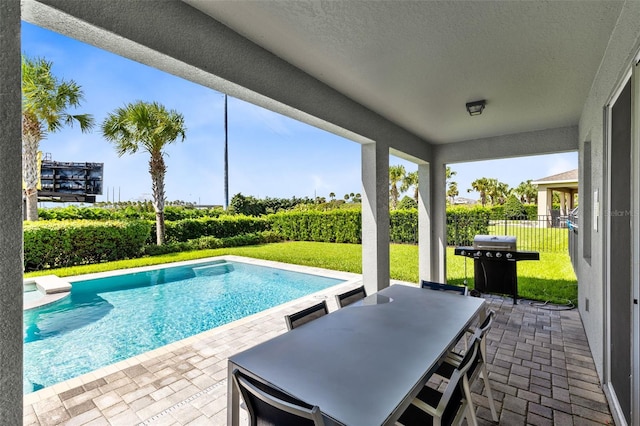 view of pool featuring a patio area, a lawn, grilling area, and fence