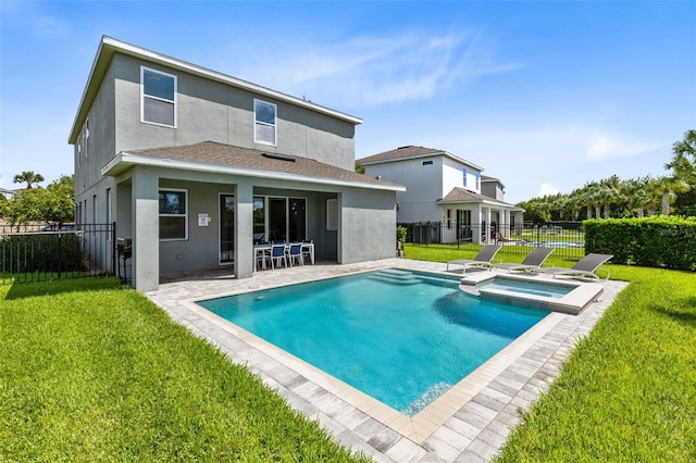 rear view of house with stucco siding, a fenced backyard, a pool with connected hot tub, and a yard