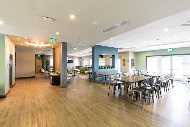 dining area featuring pool table, wood-type flooring, and decorative columns