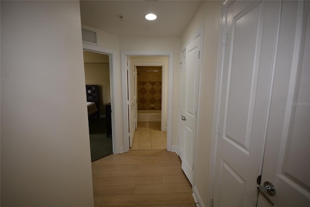 corridor featuring light hardwood / wood-style floors