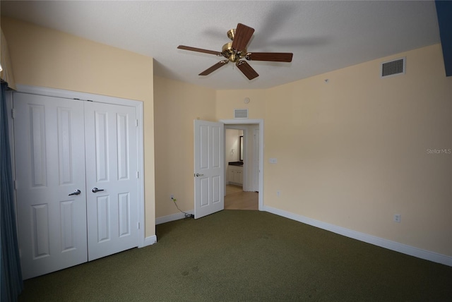 unfurnished bedroom with ceiling fan, carpet, and a closet