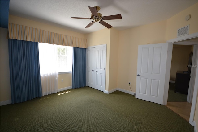 unfurnished bedroom with ceiling fan, a closet, and carpet floors