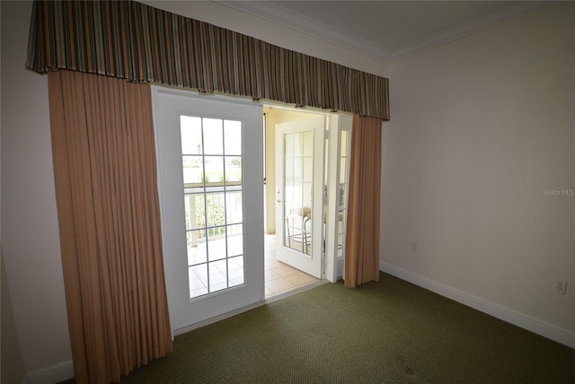 carpeted spare room featuring crown molding