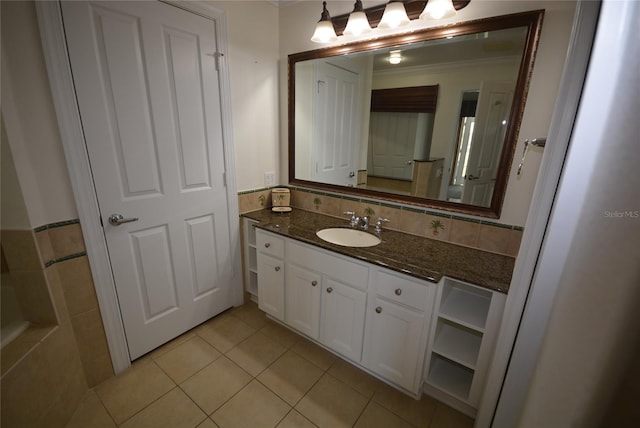 bathroom featuring backsplash, crown molding, vanity, and tile patterned floors