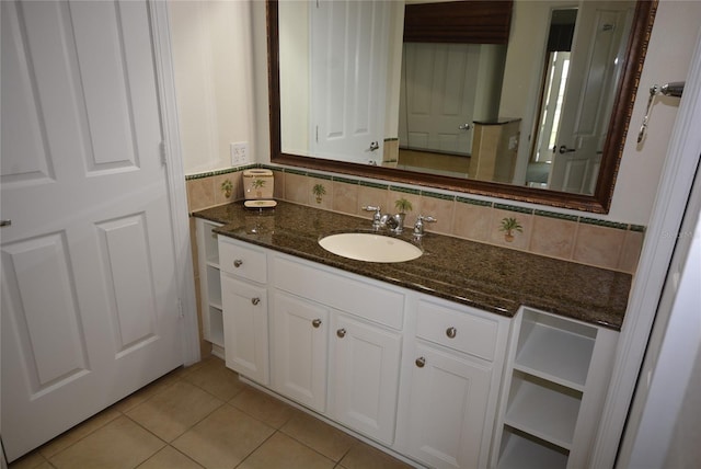 bathroom with backsplash, tile patterned flooring, and vanity