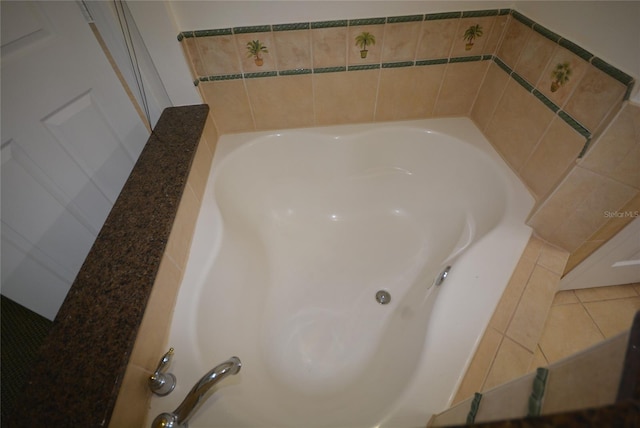 bathroom featuring tile patterned flooring and tiled tub