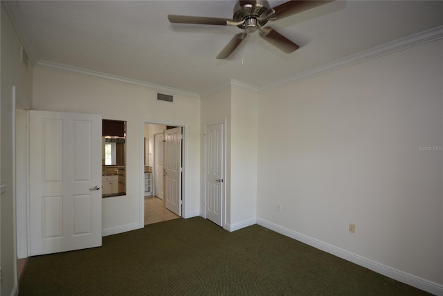 unfurnished bedroom with carpet floors, ceiling fan, and crown molding