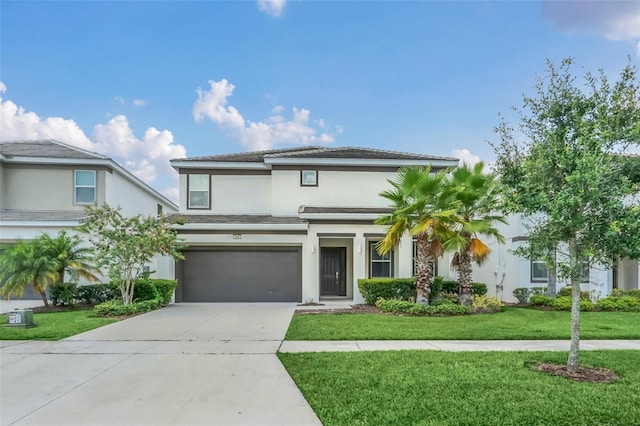 view of front of home featuring a front lawn and a garage