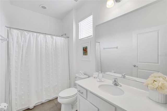 bathroom featuring tile patterned floors, toilet, and vanity