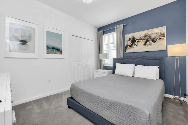 bedroom with dark colored carpet and a closet