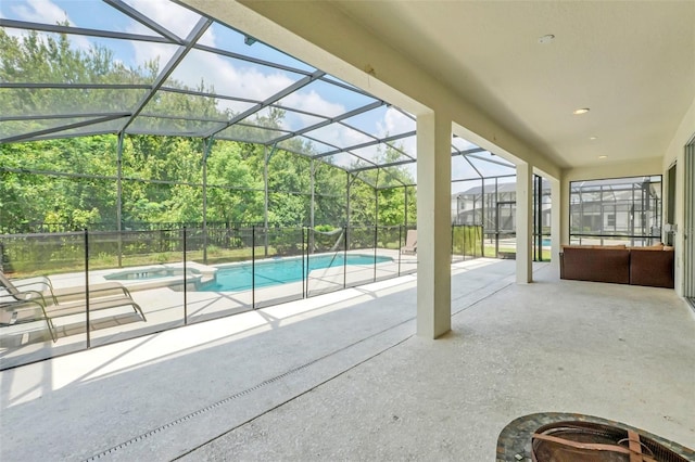 view of swimming pool with glass enclosure and a patio area