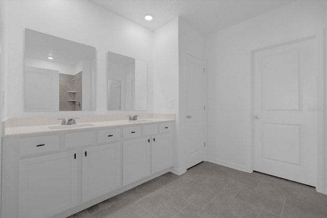 bathroom with tile patterned floors and dual vanity