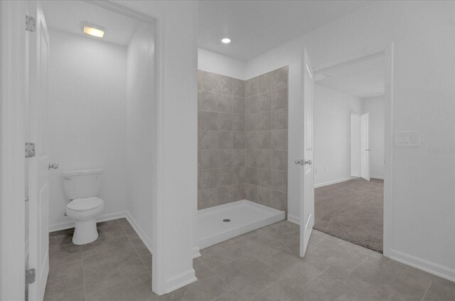 bathroom with walk in shower, toilet, and tile patterned flooring