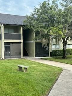 exterior space featuring a balcony and a lawn