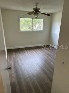 empty room featuring ceiling fan and wood-type flooring