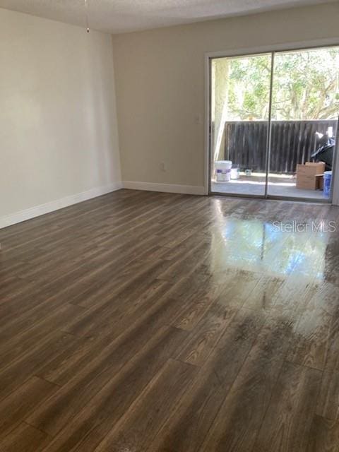 unfurnished room featuring dark hardwood / wood-style floors