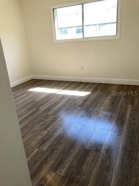 empty room featuring dark hardwood / wood-style flooring