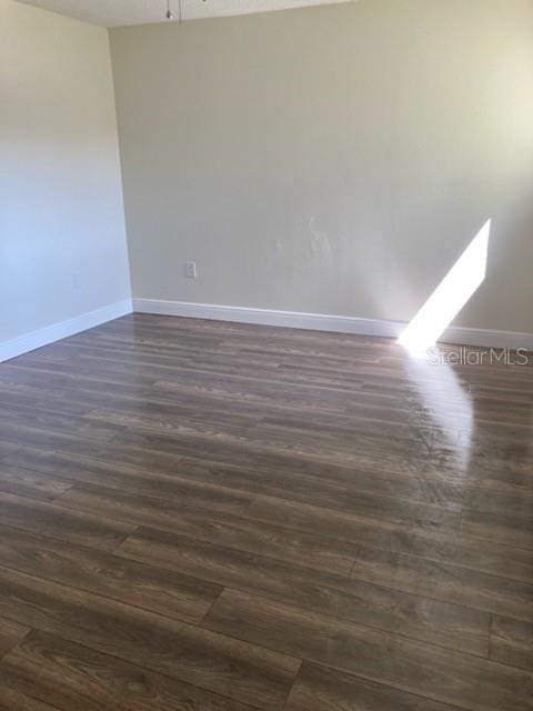 spare room featuring dark hardwood / wood-style floors