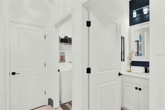 bathroom featuring washer / dryer, wood-type flooring, and vanity