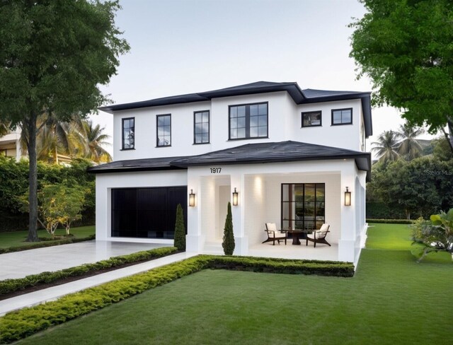 rear view of property with a yard and a patio area