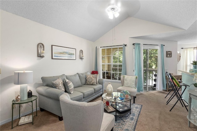 carpeted living room featuring ceiling fan, a textured ceiling, and lofted ceiling