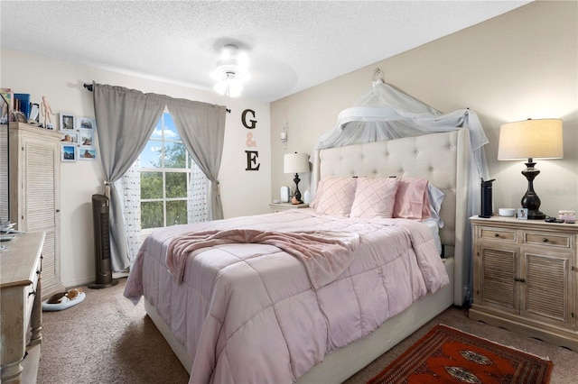 bedroom featuring ceiling fan, a textured ceiling, and carpet flooring