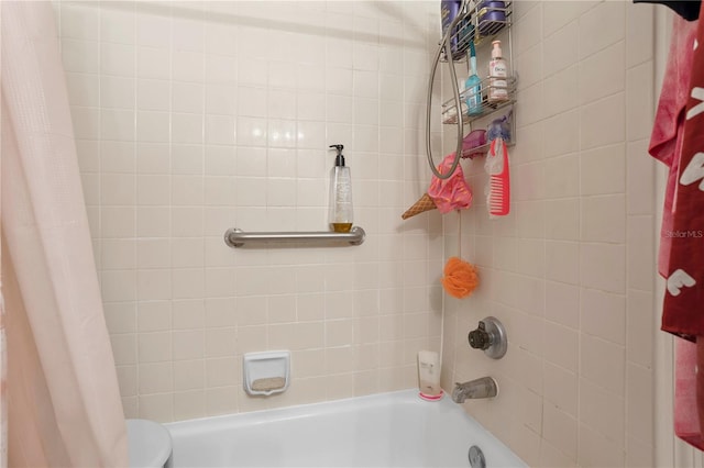 bathroom featuring toilet and shower / bath combo with shower curtain