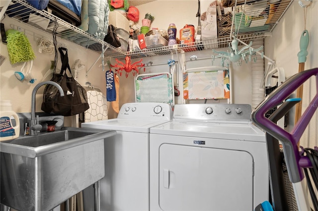 clothes washing area featuring sink and washing machine and clothes dryer