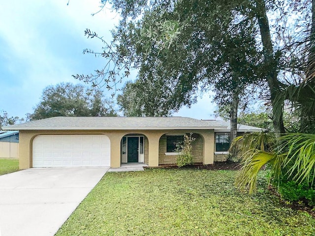 ranch-style house featuring a garage and a front lawn