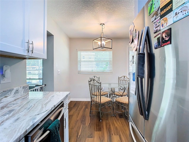 kitchen with a chandelier, white cabinetry, dark hardwood / wood-style floors, a textured ceiling, and stainless steel fridge