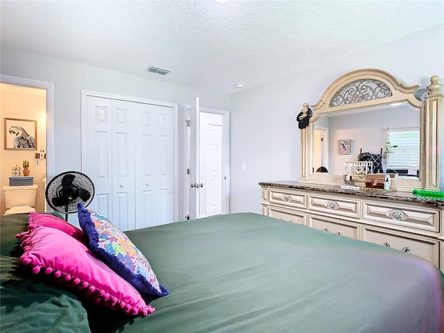 bedroom with a closet and a textured ceiling