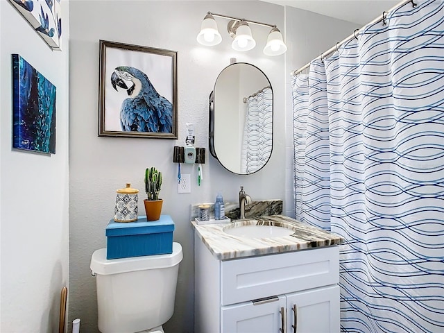 bathroom featuring toilet and vanity