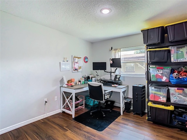 home office with a textured ceiling and hardwood / wood-style floors