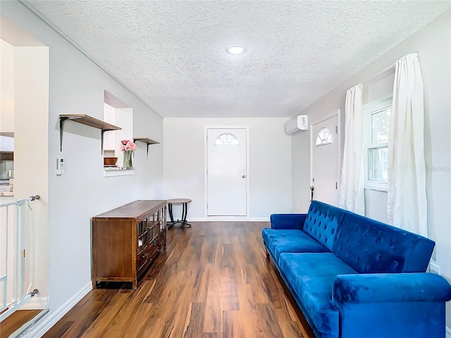 living room with dark wood-type flooring and a textured ceiling