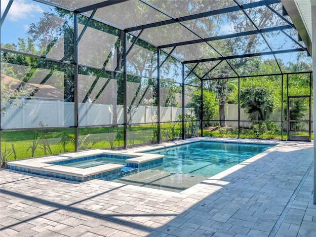 view of pool featuring an in ground hot tub, a lanai, and a patio area