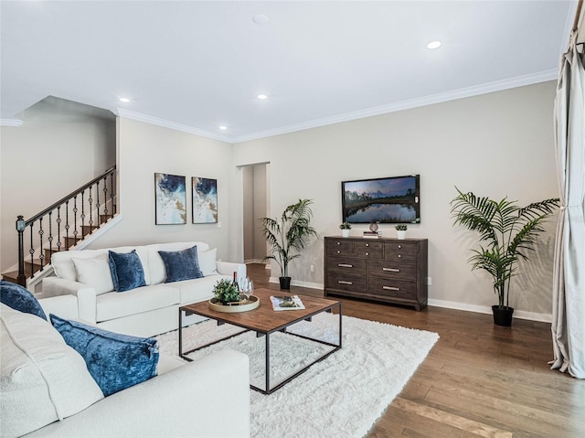 living room with hardwood / wood-style flooring and ornamental molding