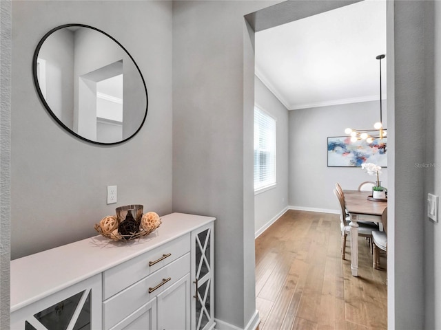 bathroom with crown molding, wood-type flooring, and a chandelier