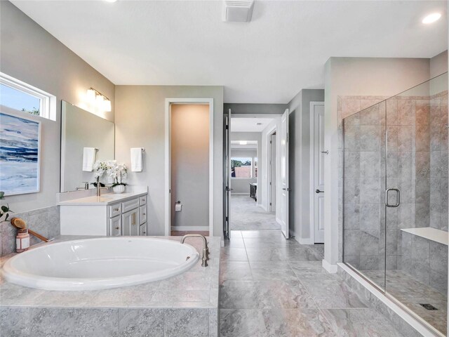 bathroom featuring vanity and separate shower and tub