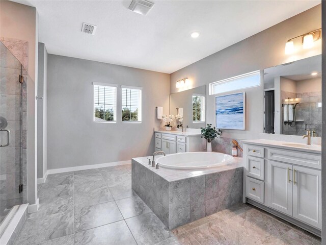 bathroom featuring vanity and shower with separate bathtub