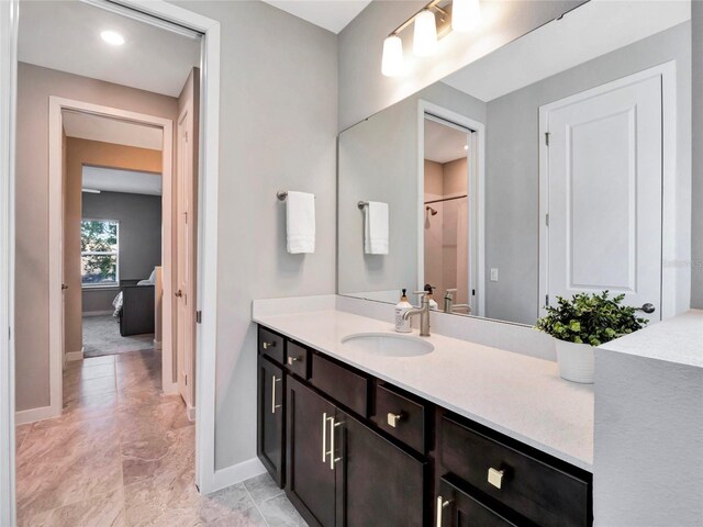 bathroom with vanity and a shower