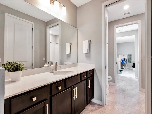 bathroom featuring vanity and toilet