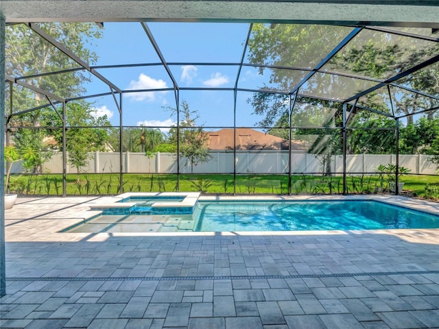 view of swimming pool featuring a lanai, a patio area, and an in ground hot tub