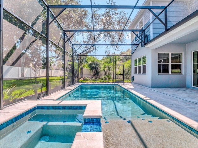 view of pool featuring an in ground hot tub, glass enclosure, and a patio area