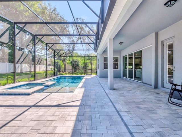 view of pool featuring an in ground hot tub, a lanai, and a patio area