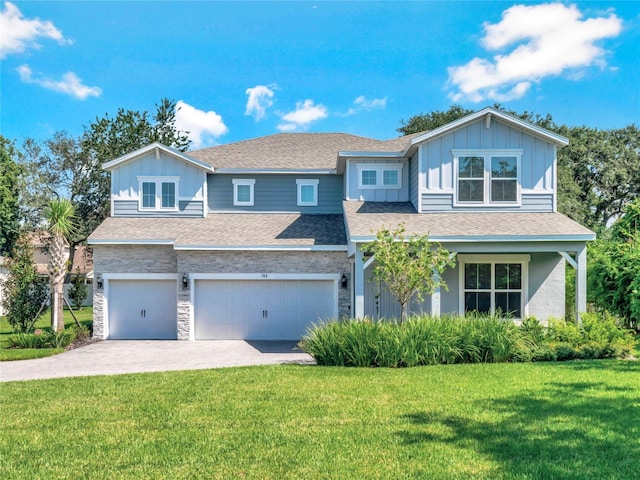 view of front of house featuring a garage and a front lawn