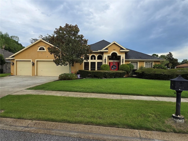 ranch-style house with a garage and a front yard