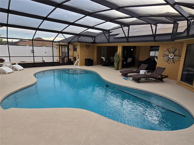 view of swimming pool featuring a patio and glass enclosure